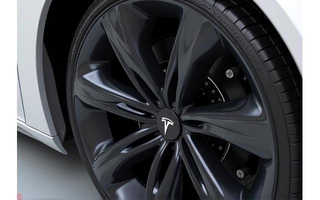 After shot of a Tesla Model Y wheel arch and undercarriage meticulously cleaned and detailed, showing intricate EV components
