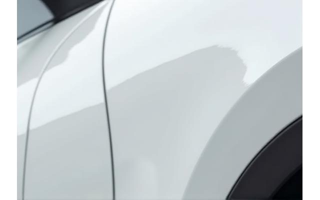 After shot showing the same car's fender, now with an invisible paint protection film applied, looking flawless and protected