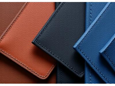Close-up of finely textured, rich brown automotive leather swatches with neat stitching.
